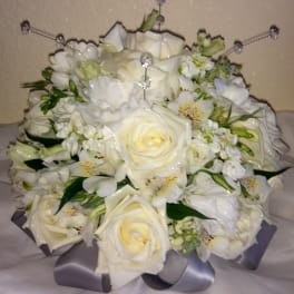 White rose bouquet with small white flowers and a silver ribbon