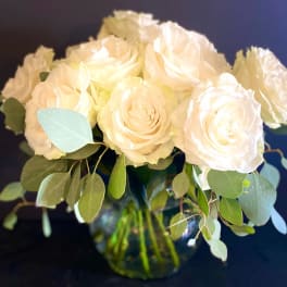 Bouquet of white roses with eucalyptus in a glass vase
