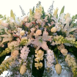 Large white floral spray with lilies and roses