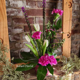 Pink and white floral arrangement with tulips and carnations in a vase