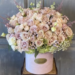 Large blush rose arrangement in a pink hat box