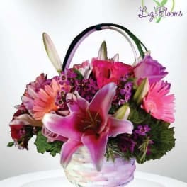 Pink and purple mixed flower basket with lilies and daisies