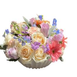 Pastel mixed flower arrangement in a white bowl vase