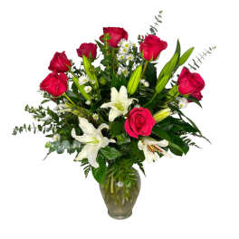 Red roses and white lilies in a glass vase