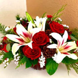 Red roses and white lilies arranged in a low vase