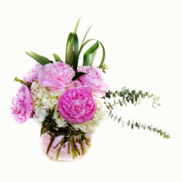 Pink peonies and white hydrangeas in a glass vase