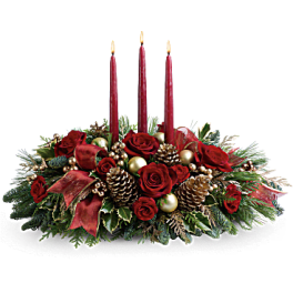 Red rose centerpiece with three red candles and pinecones