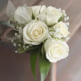 Small bouquet of white roses and a white tulip with greenery