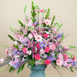 Large pastel floral arrangement in a blue vase