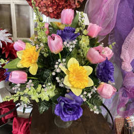 Colorful bouquet of tulips and daffodils in a glass vase