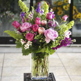 Pink and purple mixed bouquet in a clear glass vase