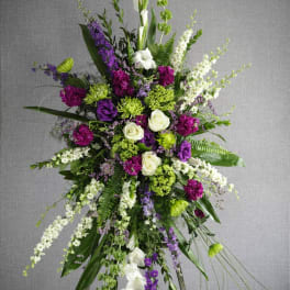 Tall standing floral spray with purple, white, and green flowers
