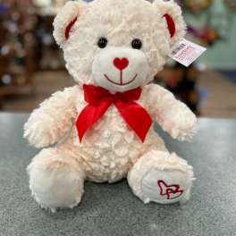 White teddy bear with a red bow and heart details