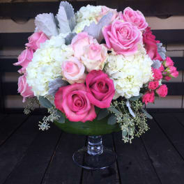 Pink and white rose bouquet in a glass vase