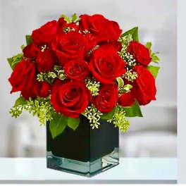 Red roses arranged in a square glass vase