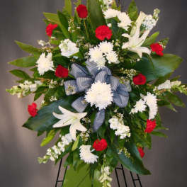 Standing floral spray with white lilies, red roses, and white chrysanthemums