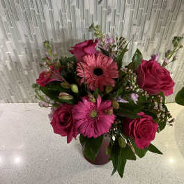 Pink roses and gerbera daisies in a vase