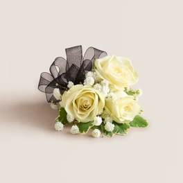 Cream rose boutonniere with black ribbon and baby's breath