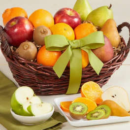 Fruit basket with apples, pears, oranges, and kiwi slices tied with a green ribbon