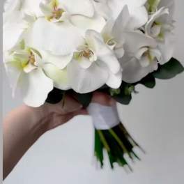 White orchid bouquet with a wrapped stem bundle