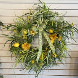 Yellow floral wreath with ribbon and lemon accents