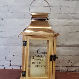 Wooden lantern with a candle and memorial text inside