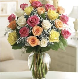 Bouquet of multicolored roses in a clear glass vase