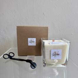 Square white candle in a glass holder with black wick trimmer and box