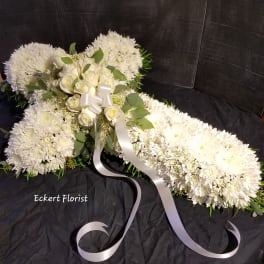 White floral spray with roses and chrysanthemums tied with a white ribbon