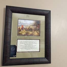 Framed wall art with a hunting scene and a Bible verse