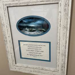 Framed wall art with a stormy ocean scene and a Bible verse