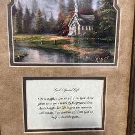 Framed landscape print above a memorial poem plaque