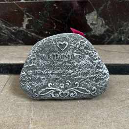 Engraved memorial stone with a heart and paw prints