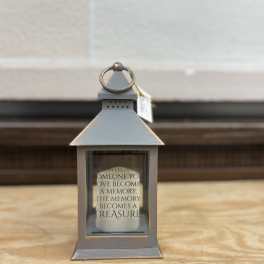Gray memorial lantern with a candle inside