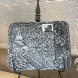 Decorative stone plaque with a cardinal and floral relief on a display stand