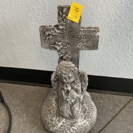 Stone angel memorial cross with floral relief and a yellow price tag