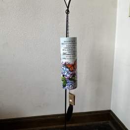 Tall memorial wind chime on a black stand with printed flowers, butterfly, and remembrance verse.