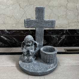 Stone memorial cross with an angel statue and basket planter