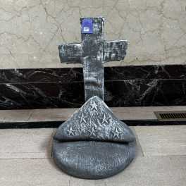 Decorative cross sculpture with a star-patterned base