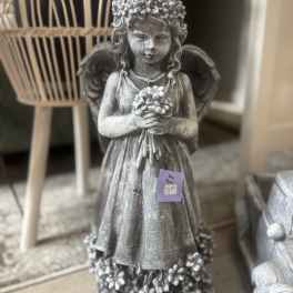 Gray angel statue holding flowers
