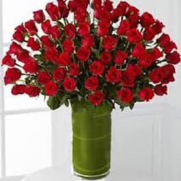 Bouquet of red roses in a tall green vase