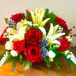 Red and white floral arrangement with lilies and roses