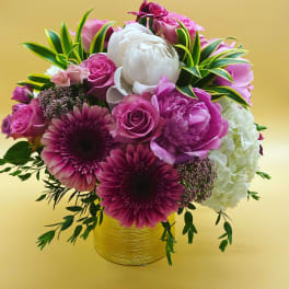 Pink and white mixed bouquet in a gold vase