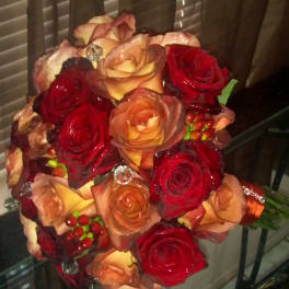 Bouquet of red and peach roses with decorative berries