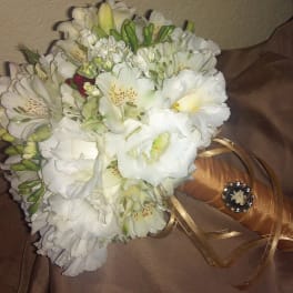 White flower bouquet with a gold ribbon-wrapped handle