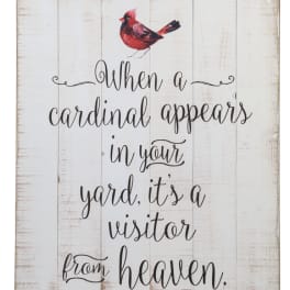 Wooden sign with a red cardinal and the phrase "When a cardinal appears in your yard, it's a visitor from heaven."