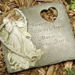 Memorial stone with an angel relief and heart cutout