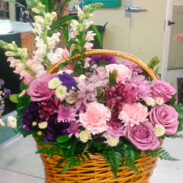 Basket of pink and purple flowers with tall white blooms