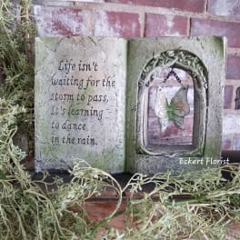 Decorative open-book plaque with a butterfly ornament and quote