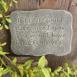 Gray memorial stone with an engraved sympathy quote